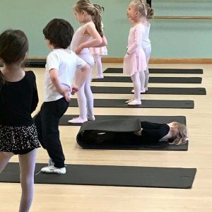 little-girl-sleeping-on-yoga-mat-300x300
